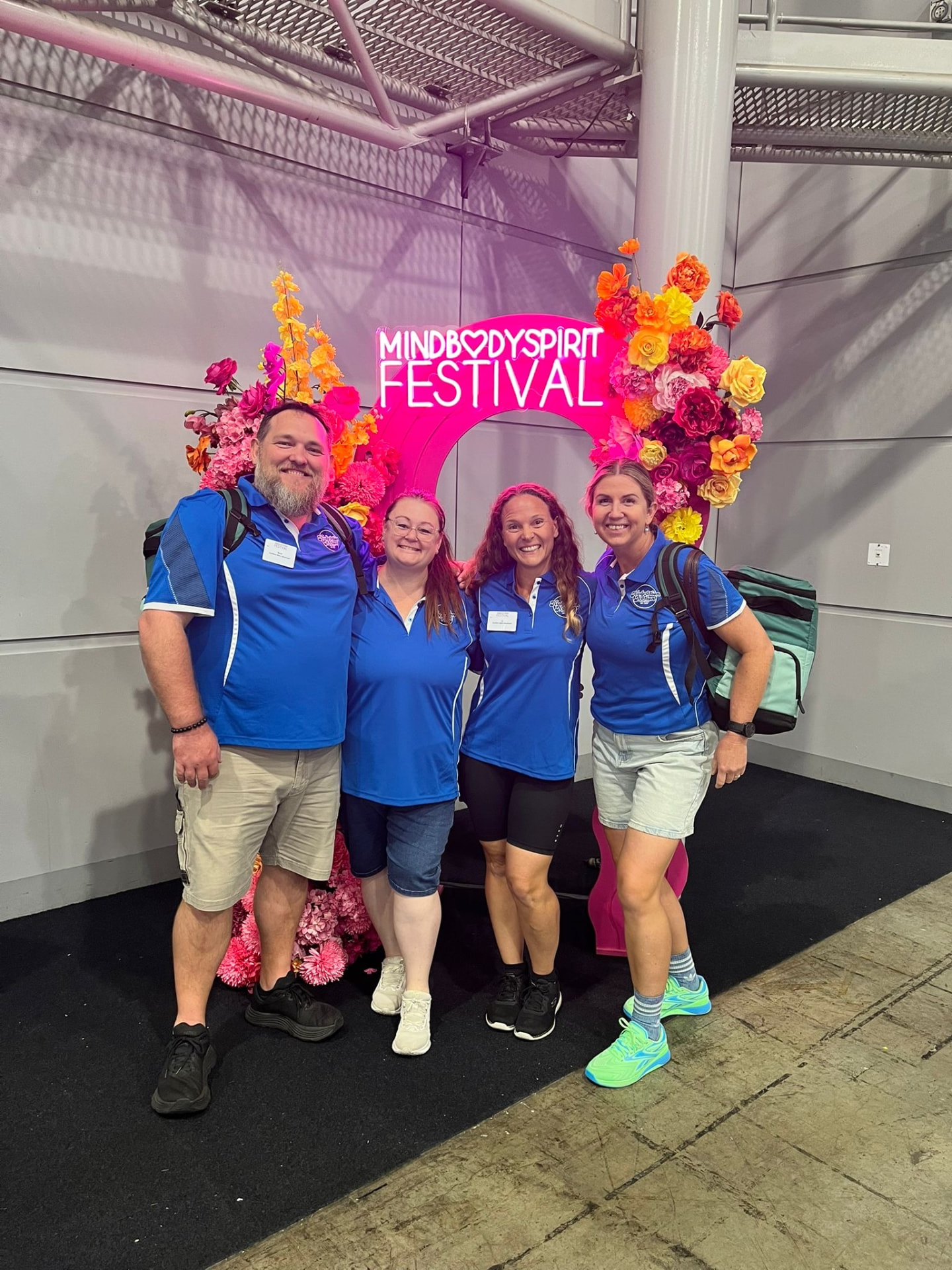 Hydr8tion N8tion team in front of the MindBodySpirit Festival sign