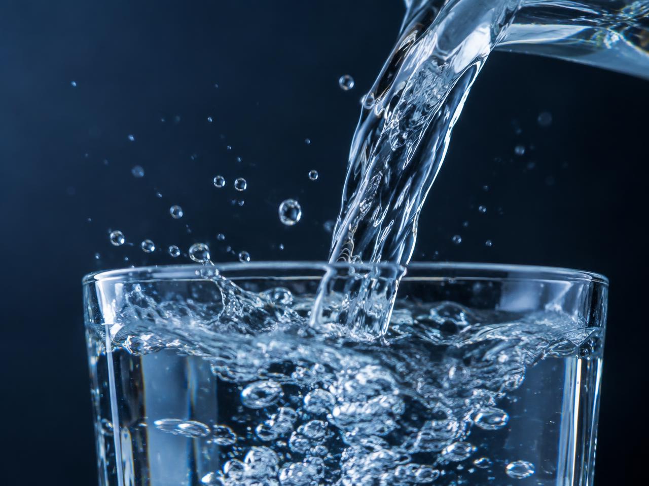 Clear water pouring into a glass